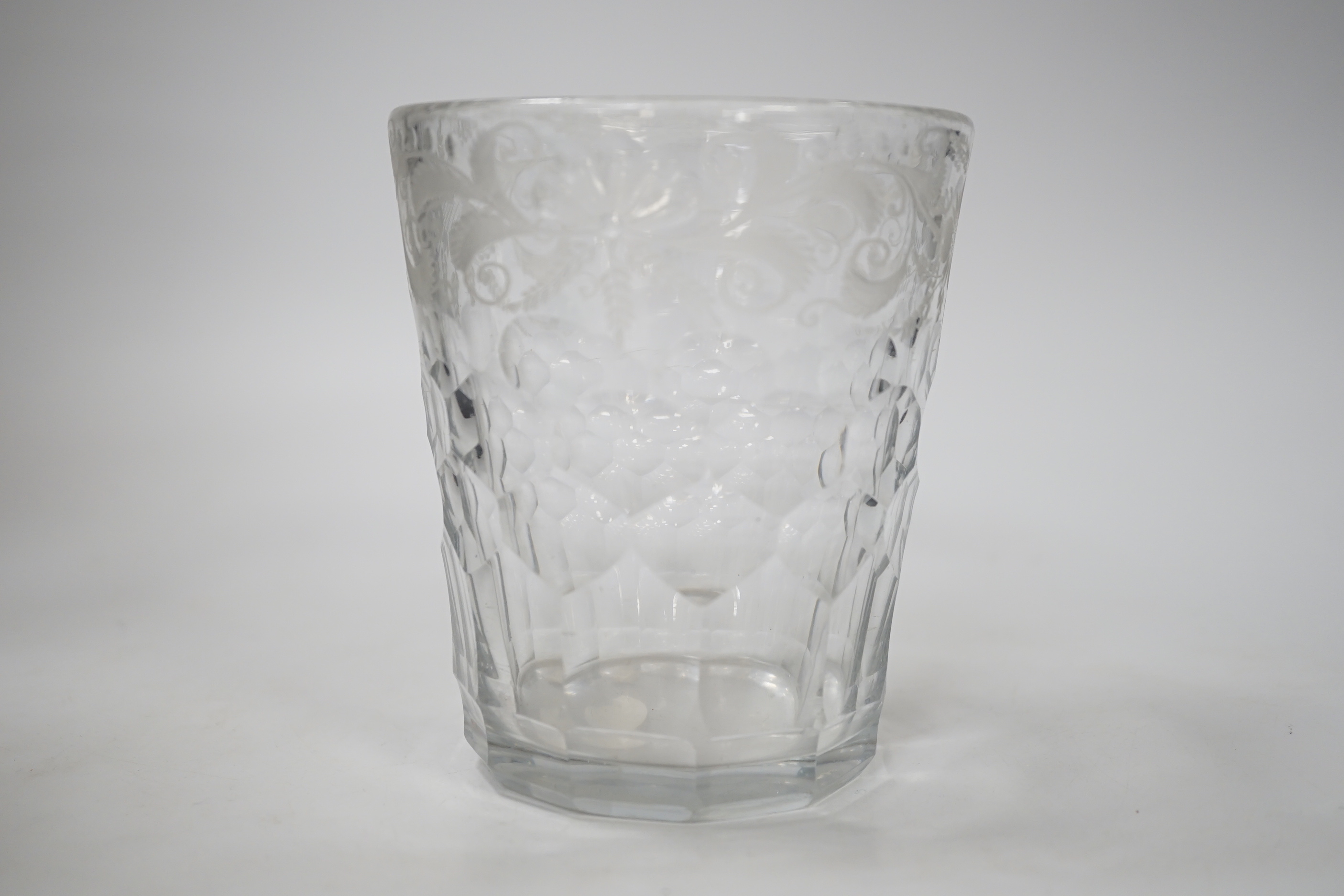 An English lead crystal 18th century faceted tumbler, in a darkish grey metal, upper decoration engraved and polished floral centre, three rows of facets running into plain facets, whole of foot polished to remove pontil